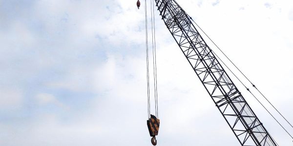 A boom or lattice boom and hook on a crawler crane, also known as a lattice boom crane.